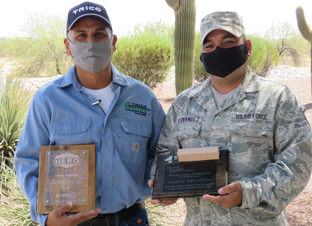 Trico Electric Cooperative’s Jaime Esparza (l) is a “hometown hero” for helping an Arizona food bank. Also shown is Master Sgt. Omar Fernandez. (Photo Courtesy: Trico EC)