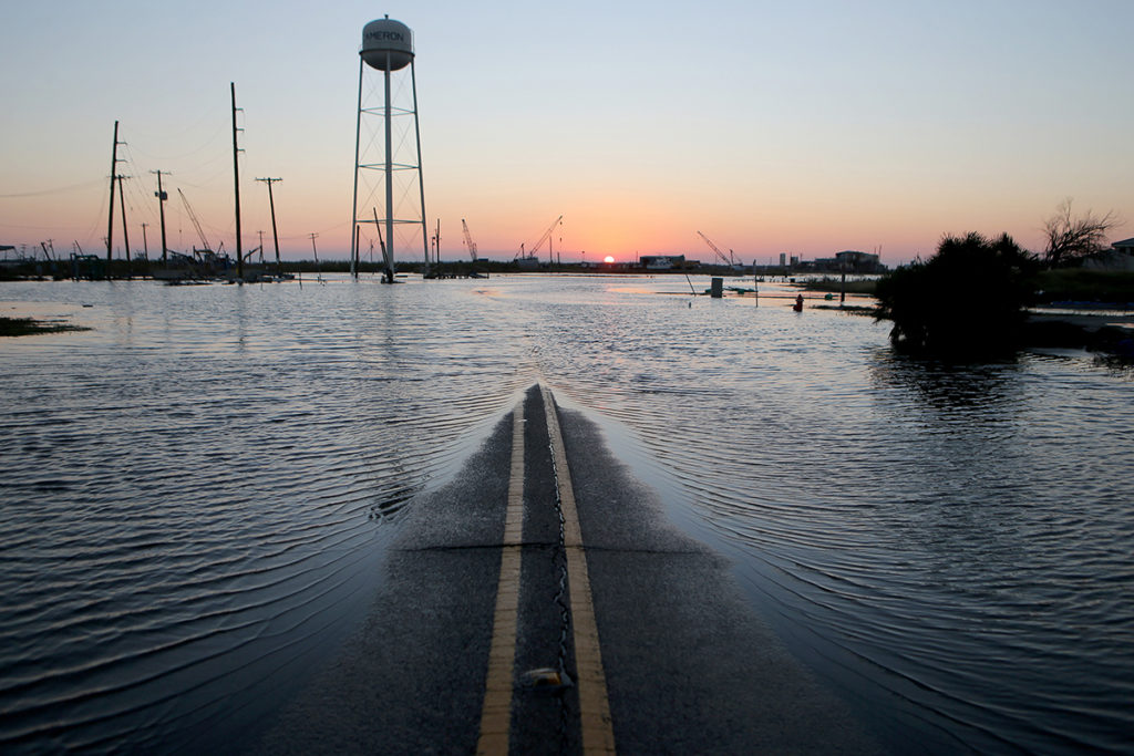A day after Hurricane Delta made landfall as a Category 2 storm, floodwaters cover a roadway near structures damaged by Hurricane Laura in Cameron, Louisiana. (Photo By: Mario Tama/Getty Images)