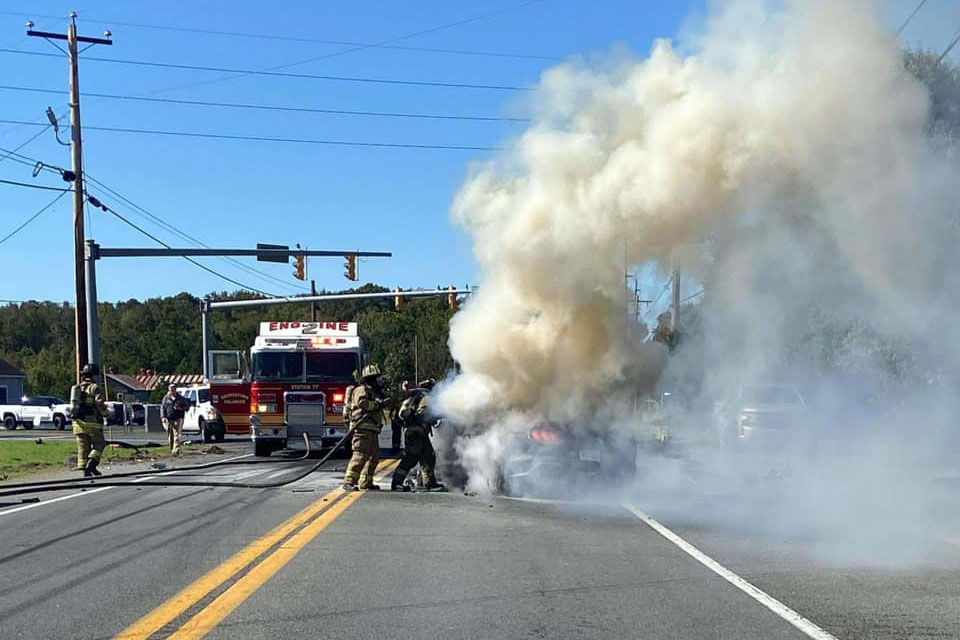 Near Georgetown, Delaware, firefighters douse flames from a car involved in a tractor-tractor collision. Moments before, Delaware EC’s Sheron Sturgis helped rescue the trapped motorist.  (Photo Courtesy of Georgetown Fire Co.)