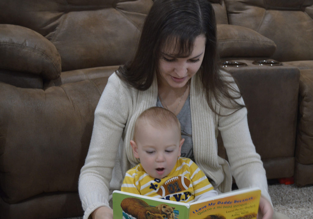 Highline Electric Association’s Jessie Heath and her son, Harrison, snuggle up with a book from Dolly Parton’s Imagination Library. The Colorado co-op is helping expand the program in its communities. (Photo By: Scott Heath)
