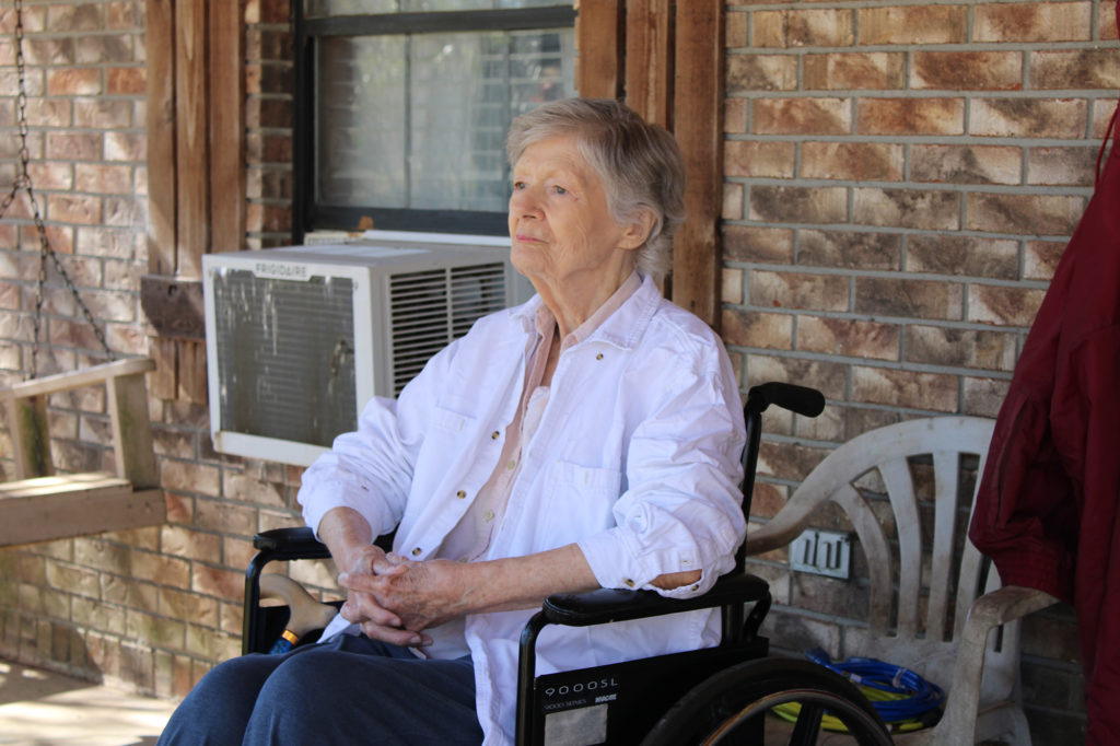Katherine McCardle Cole, 83, sits on her front porch, where she saw Dixie Electric Power Association hang fiber-optic cable to deliver broadband internet. She had the same view as a child when the co-op electrified her house. (Photo By: Dixie Electric)