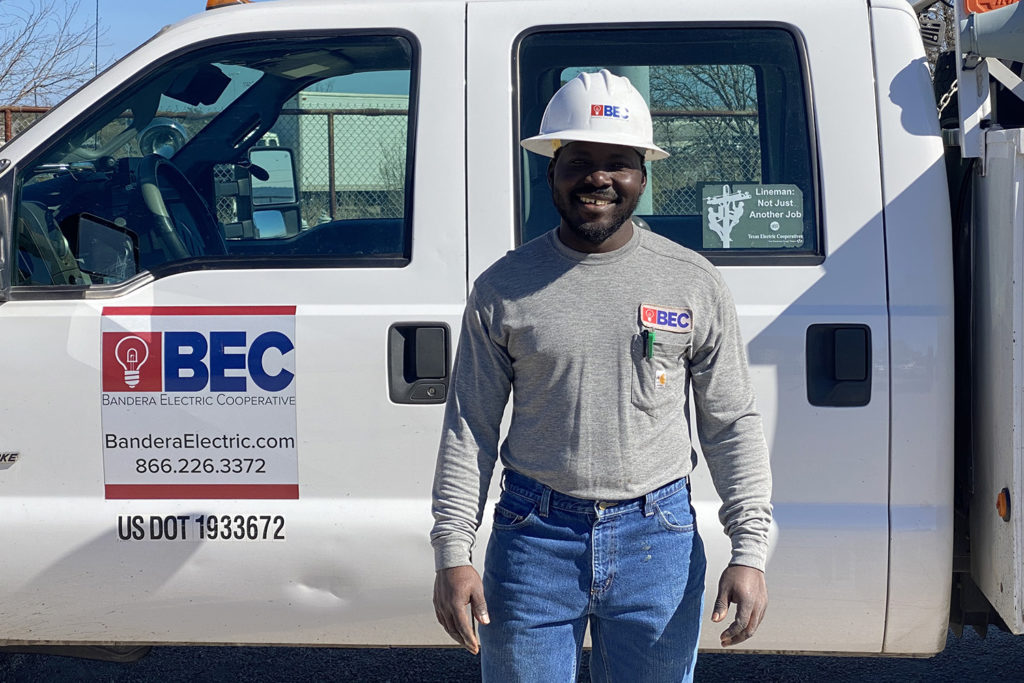 Bandera Electric Cooperative’s Gimps Louis-Charles is a lineman second class at the Bandera, Texas, co-op. He met his current coworkers several years ago in Haiti, as a contractor at an NRECA International project. (Courtesy: Bandera Electric Cooperative )