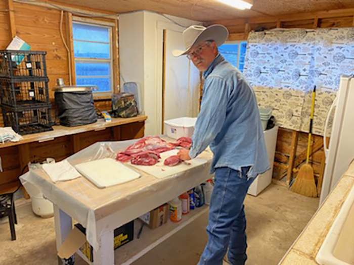 Pedernales Electric Co-op’s Charles Herbst in his Junction County, Texas, ranch, where he and his colleagues process and package ground venison for hungry families. (Photo Courtesy: Charles Herbst)