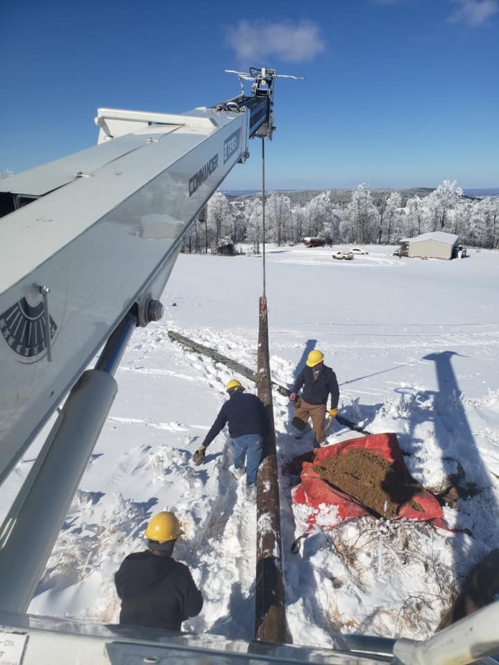 Crews from Petit Jean Electric Cooperative prepare to raise a new pole into position during restoration work near Clinton, Arkansas. (Photo By: Petit Jean EC)