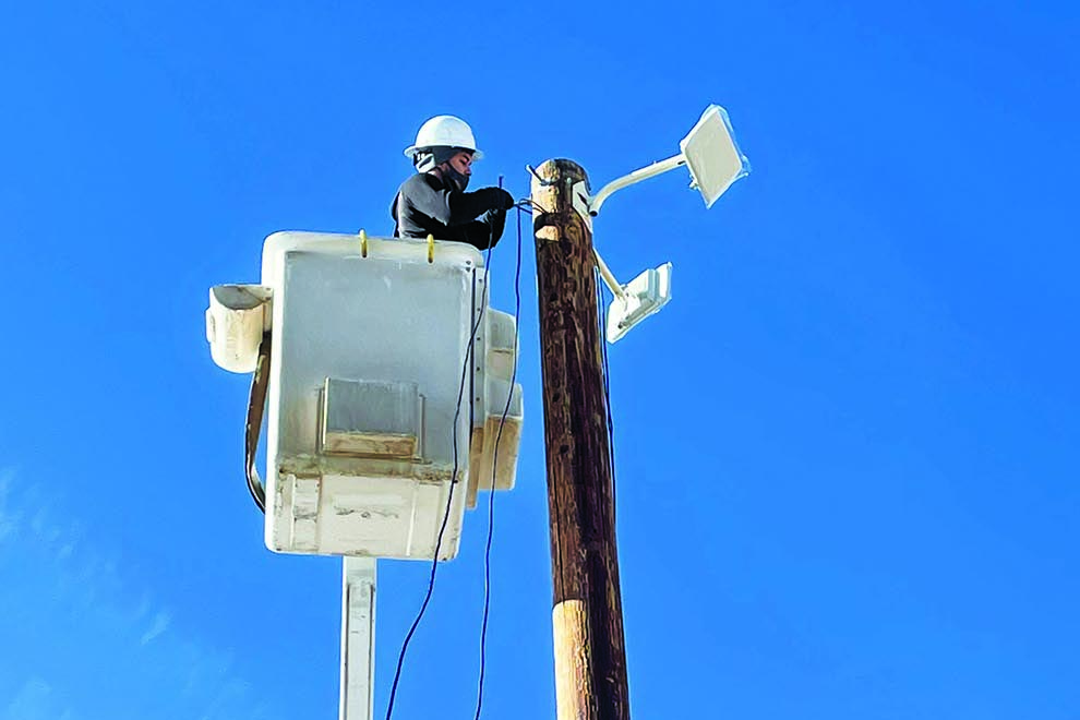 Ciello sets up a temporary pole and equips it to provide wireless broadband to a mobile home park where students lack sufficient internet access for online school during the pandemic. (Photo Courtesy: Ciello)